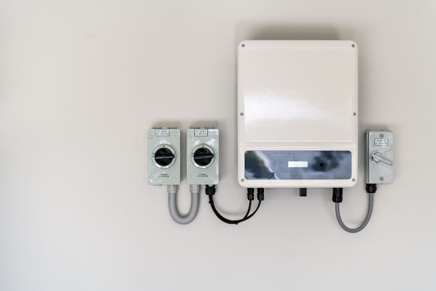 Solar panel inverter and isolators attached to the wall
